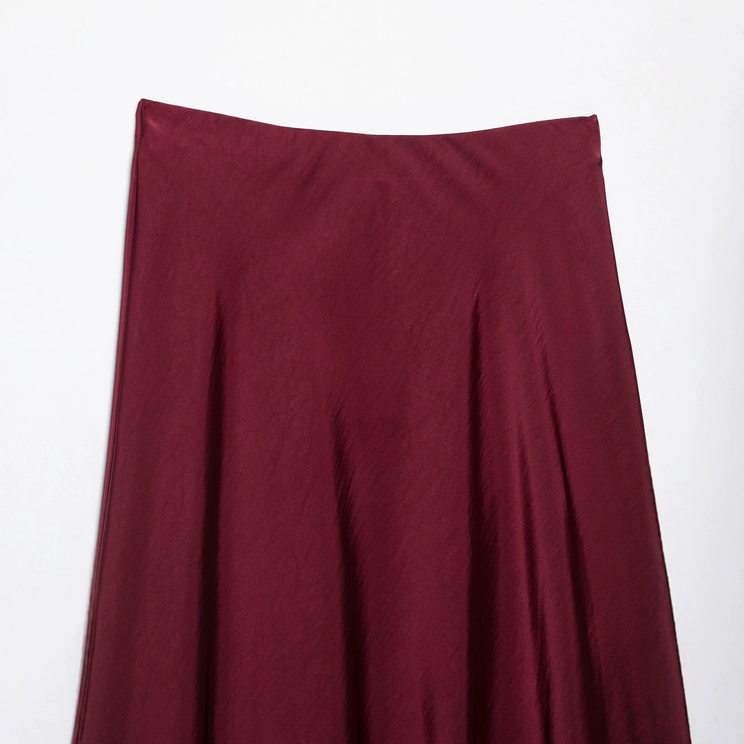 Women's flowy midi skirt in satin look with high waistband and asymmetrical hem Mune Fashion