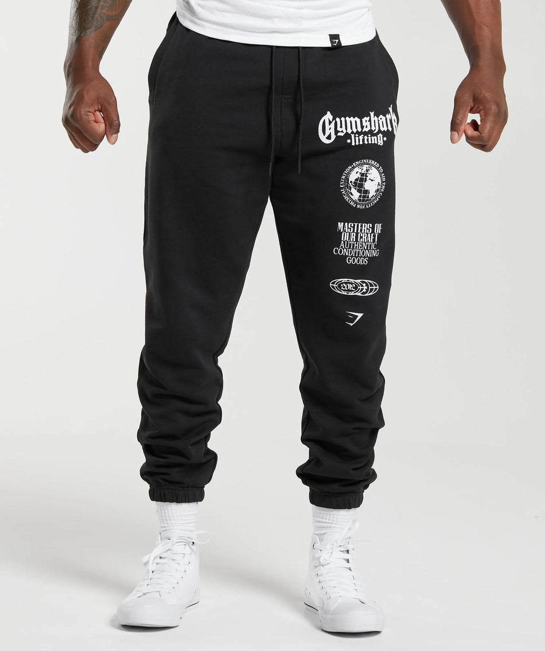Men's tapered cotton fleece sweatpants with an elastic drawstring waistband, ribbed leg openings, and large logo print Mune Fashion