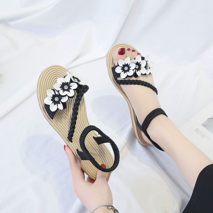 Women's playful strap sandal with braided decorative bands, flower appliqués, and elastic heel strap Mune Fashion