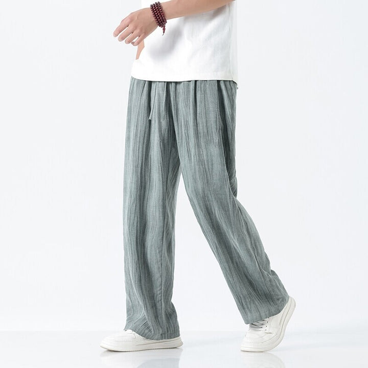 Men's loose linen trousers with adjustable drawstring waistband, casual pleat look, and side pockets Mune Fashion