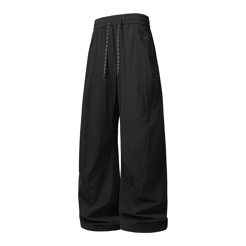 Unisex Wide Tech Baggy Pants with elastic drawstring, zip pockets & water-repellent nylon look Mune Fashion