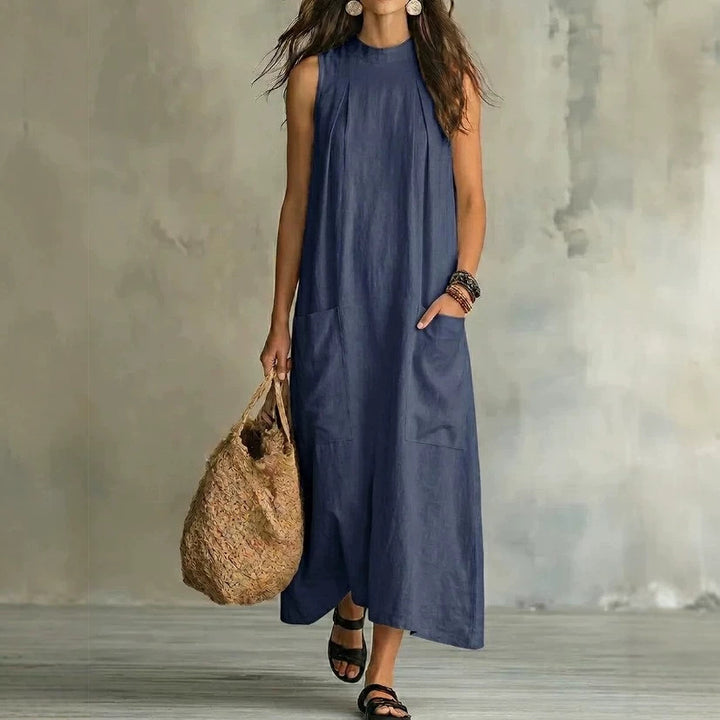 Women’s sleeveless linen maxi dress with standing collar, pleats at the chest, and piled pockets Mune Fashion