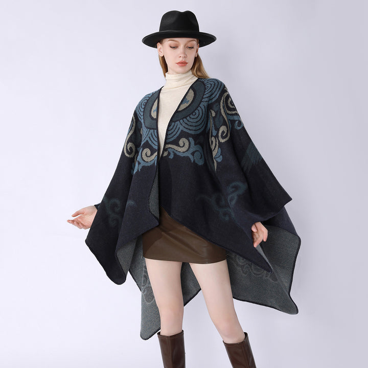 Women's wool blend cape with ornamental jacquard, asymmetrical tip and soft falling oversized drape.