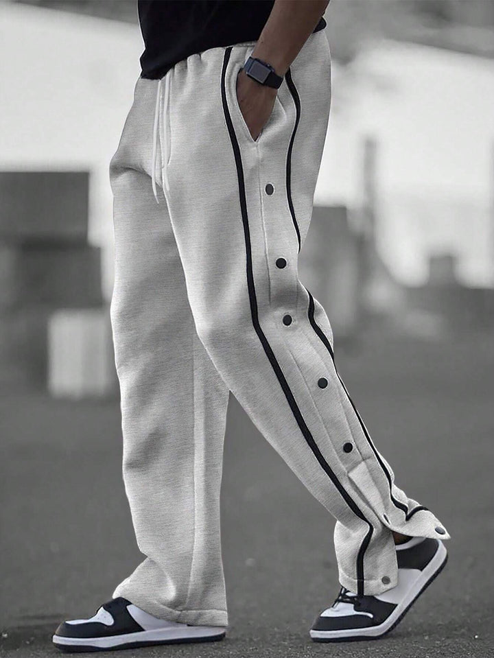 Men's casual training pants with side snap button placket, elastic waistband and contrasting piping Mune Fashion
