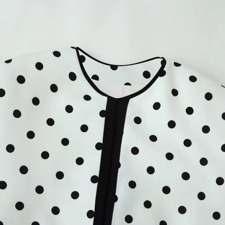 Women's short blazer in polka dot design with round neckline, short cut and contrast piping Mune Fashion