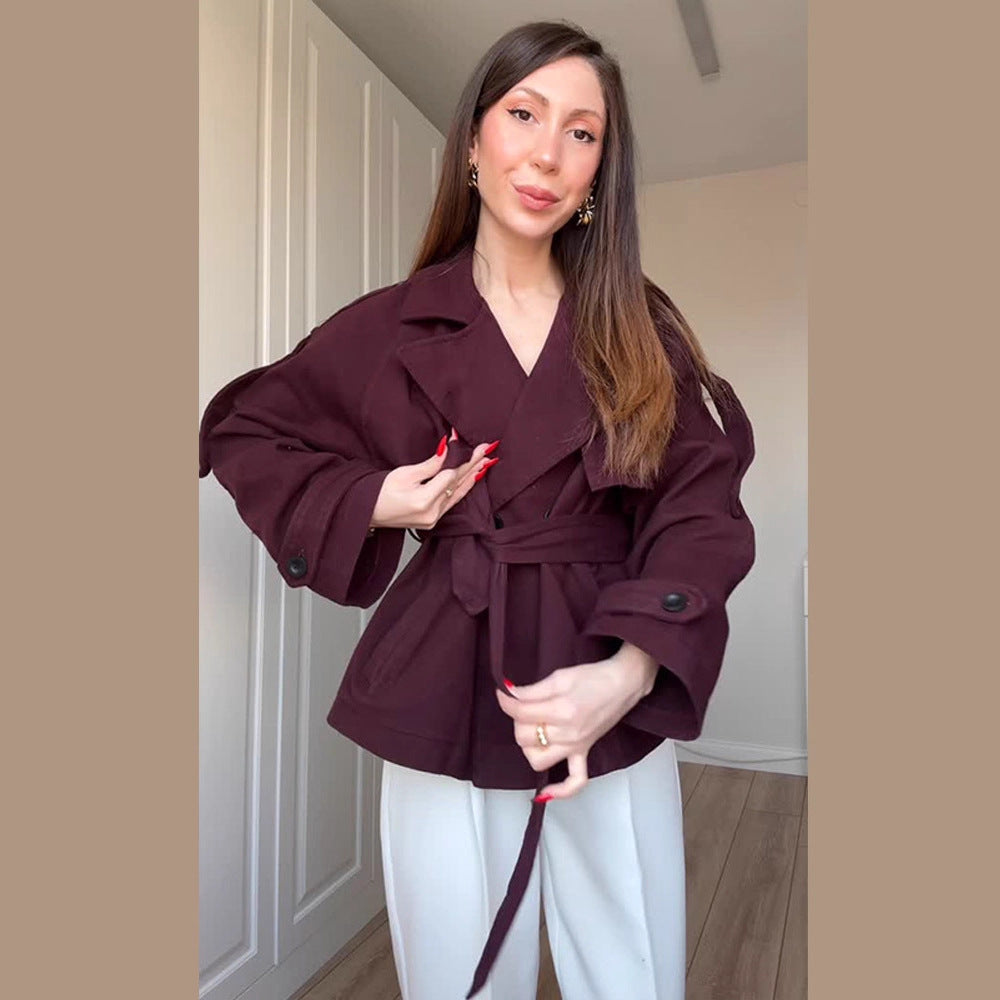 Women's short trench-style jacket with belted waist, oversized sleeves, and boxy cropped silhouette Mune Fashion
