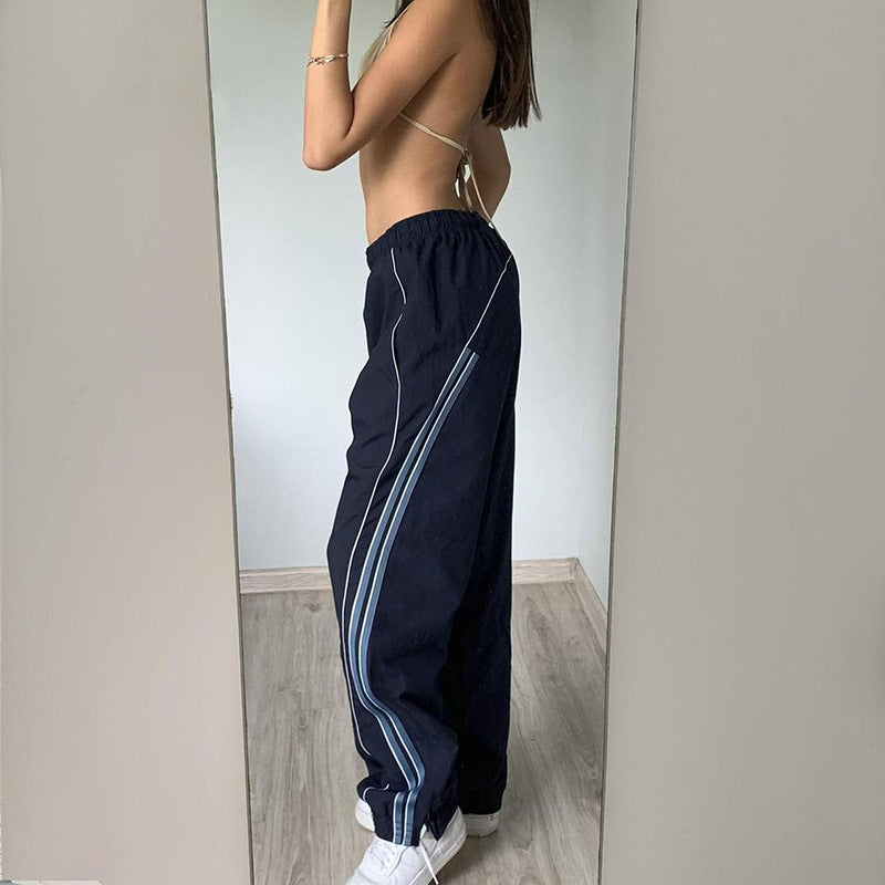 Ladies' sporty training pants with straight leg, elastic comfort waistband, and decorative side piping Mune Fashion