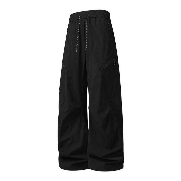 Men's Oversize Utility Cargo Pants made of lightweight nylon with elastic drawstring waistband, side zipper pockets & wide balloon silhouette Mune Fashion