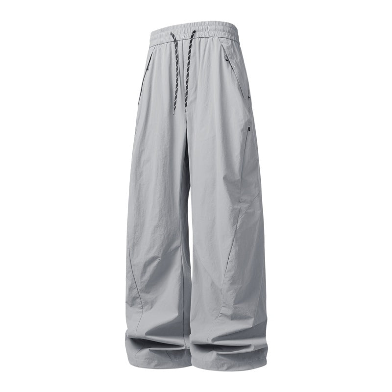 Unisex Wide Tech Baggy Pants with elastic drawstring, zip pockets & water-repellent nylon look Mune Fashion