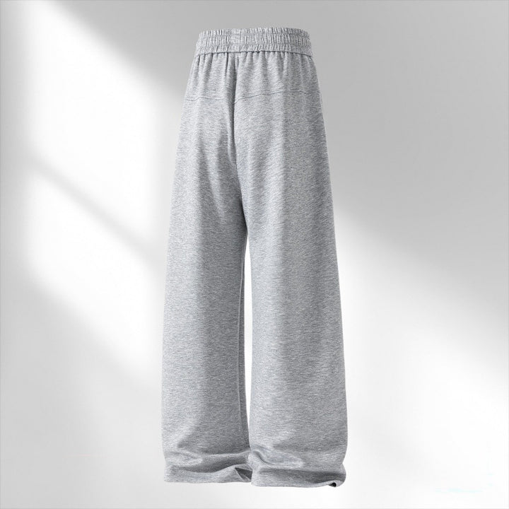 Women's wide lounge sweatpants with elastic drawstring waistband and decorative side seam details Mune Fashion