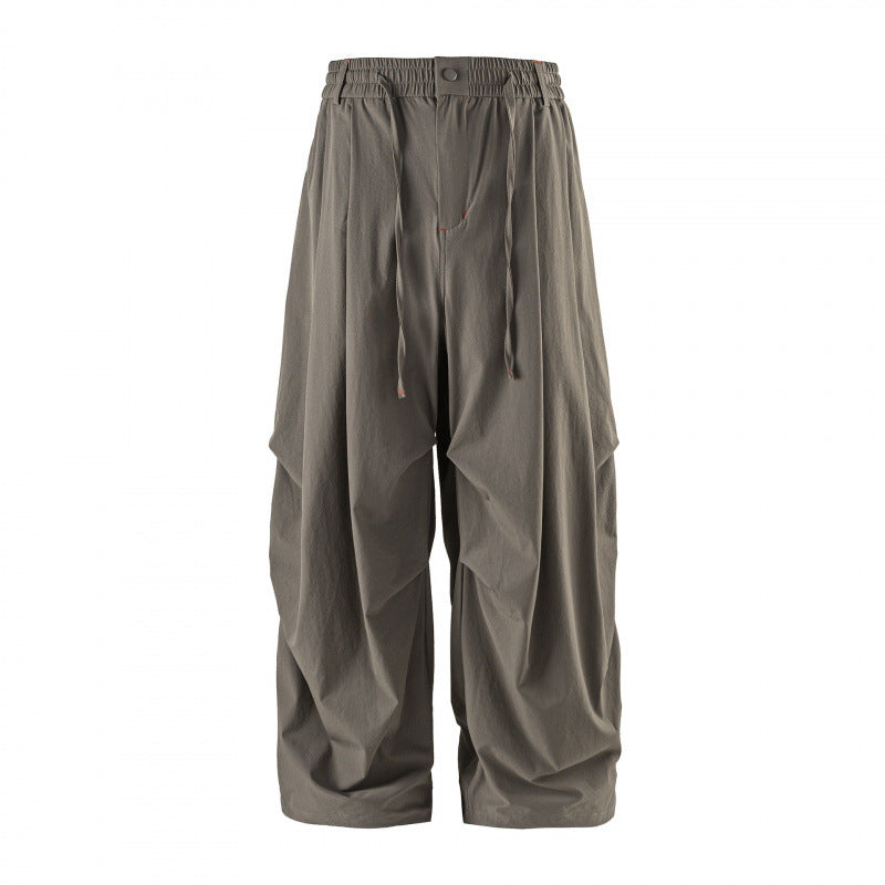 Unisex Loose-fitting technical cargo pants with elastic waistband, drawstring, and zip pockets Mune Fashion