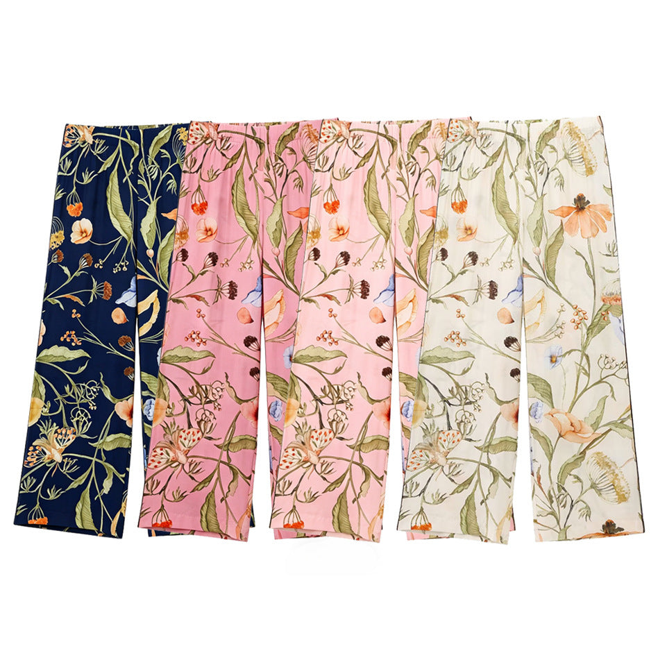 Women's wide high-waisted satin pants with floral all-over print and elastic waistband Mune Fashion