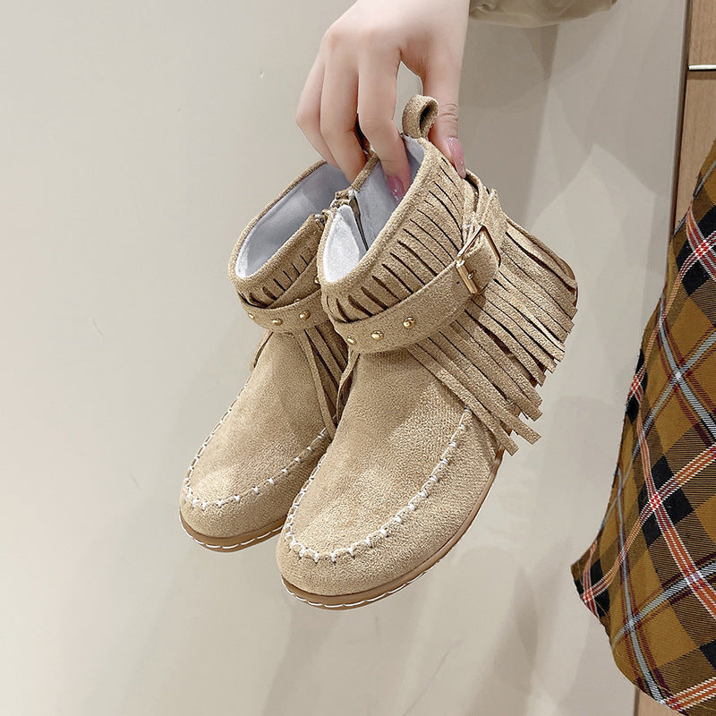 Women's fringe ankle boot in moccasin style with decorative studs, buckle strap, and side zipper Mune Fashion