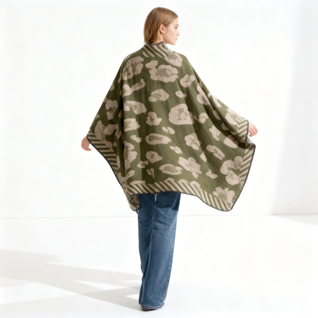 Women's chunky knit wool cape in a wrap style with abstract leopard pattern and decorative edge Mune Fashion