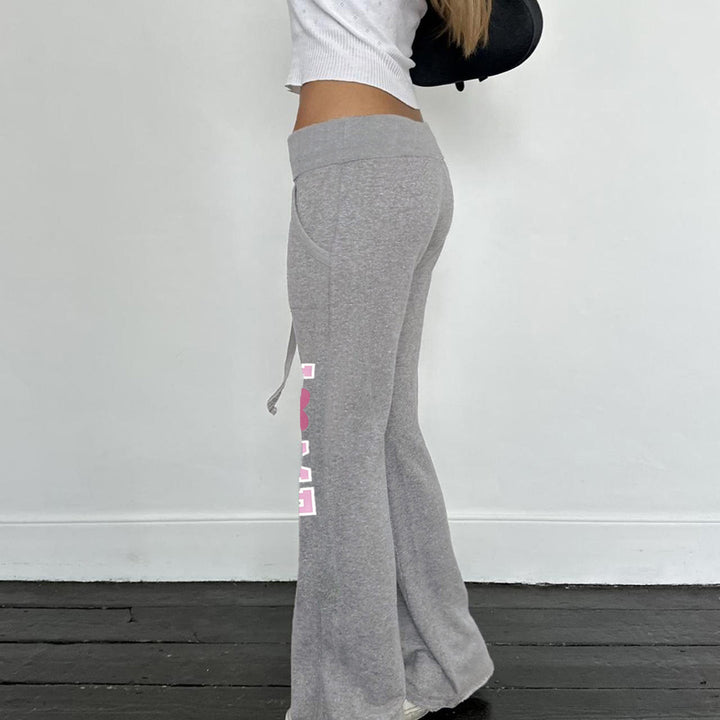 Women's soft flared jogging pants with drawstring, side pockets, and eye-catching Love print Mune Fashion