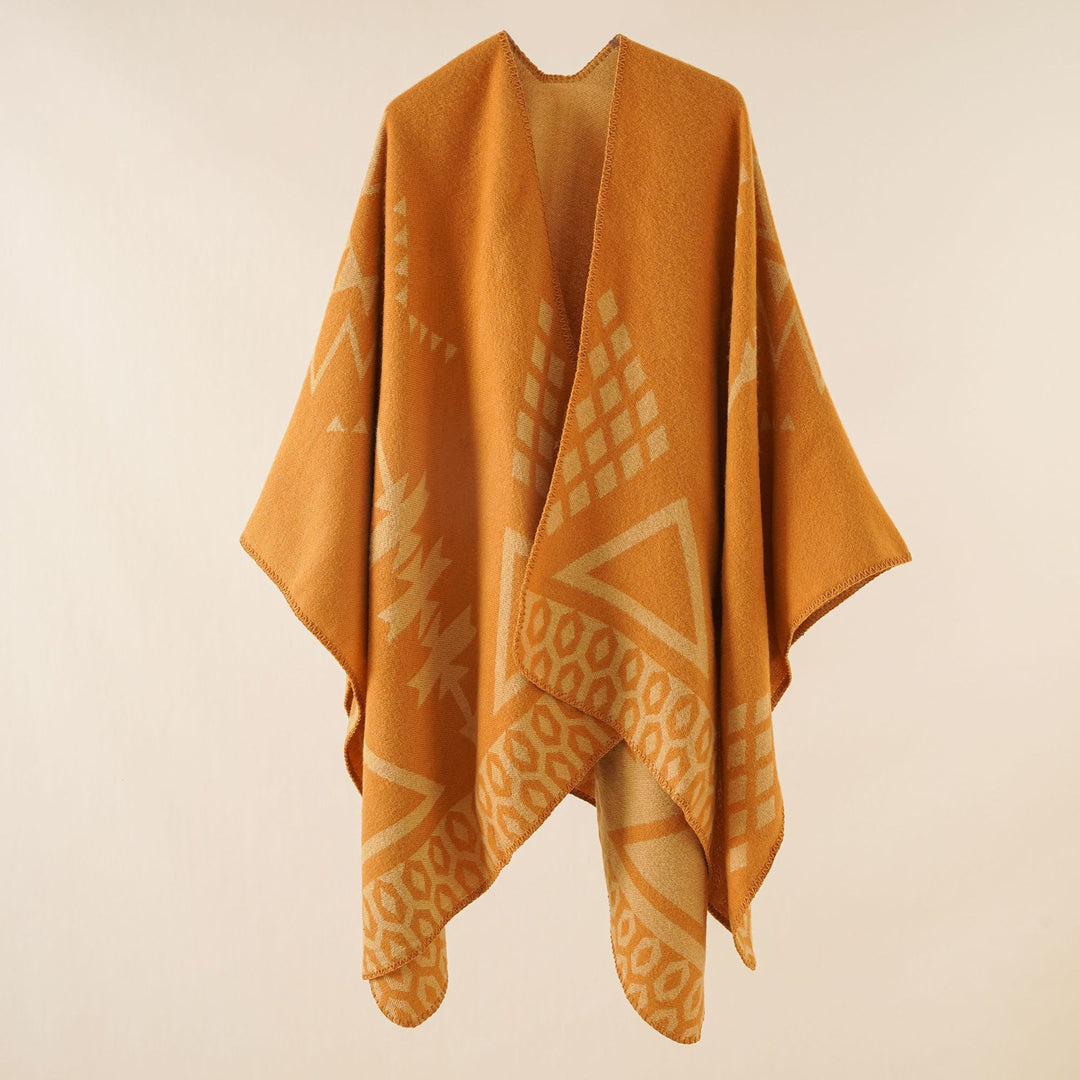 Women's oversized Ruana poncho with cashmere touch, geometric jacquard, and open kimono silhouette.