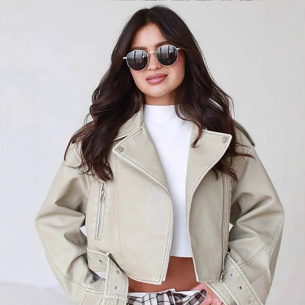 Women's short biker jacket made of vegan leather with a wide waist belt and visible decorative stitching Mune Fashion