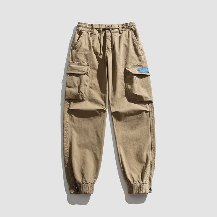 Herren Konisch geschnittene Utility-Cargo-Jogginghose mit Tunnelzugbund, Klapptaschen und Knöchelreißverschlüssen Mune Fashion