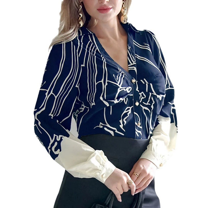 Women's V-neck blouse with abstract graphic print, balloon sleeves, and contrasting cuffs Mune Fashion