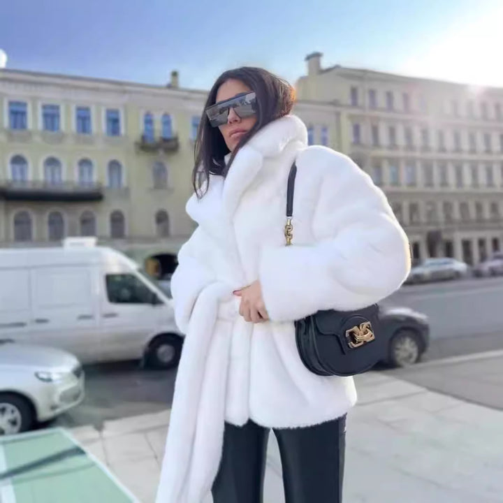 Ladies short coat made of luxurious faux fur with a waist belt and high shawl collar Mune Fashion