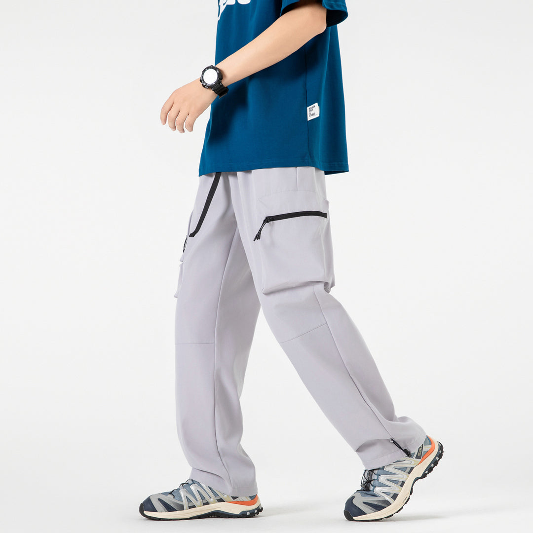 Men's loose technical cargo pants with multi-functional pockets, drawstring waistband, and adjustable leg closures Drune
