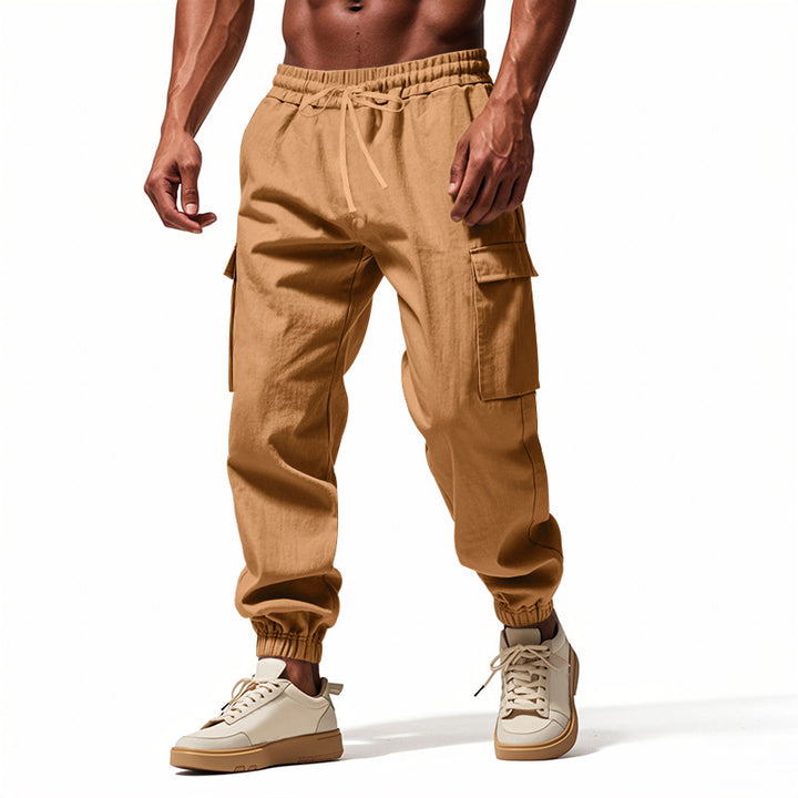 Men's tapered joggers in utilitarian style with elastic waistband, drawstring, and flap pockets Mune Fashion