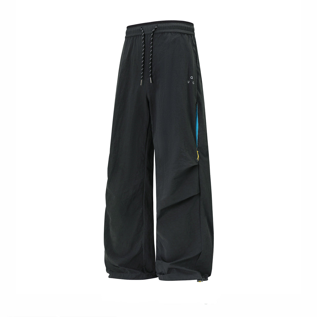 Unisex wide technical cargo pants with drawstring waistband, zip pockets, and adjustable hem Mune Fashion