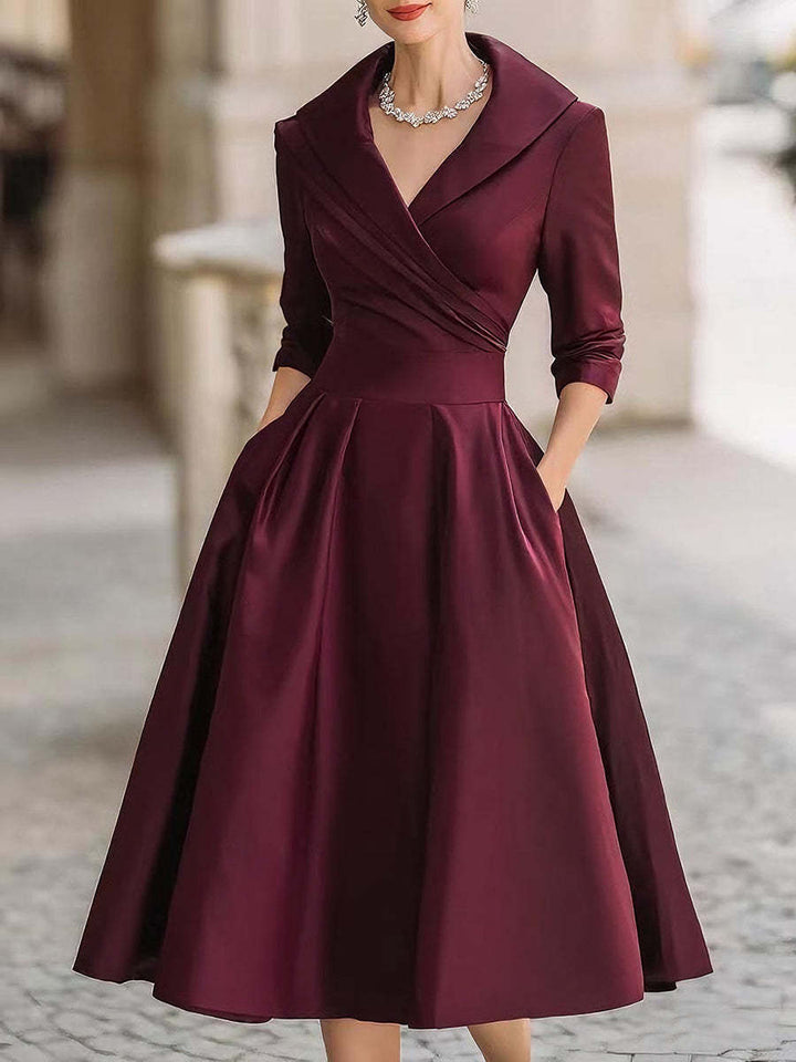 Women's elegant midi dress with wrap top, three-quarter sleeves, and side pockets Mune Fashion