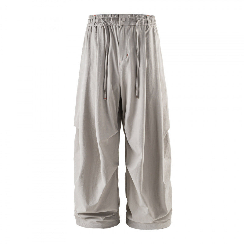 Unisex Loose-fitting technical cargo pants with elastic waistband, drawstring, and zip pockets Mune Fashion