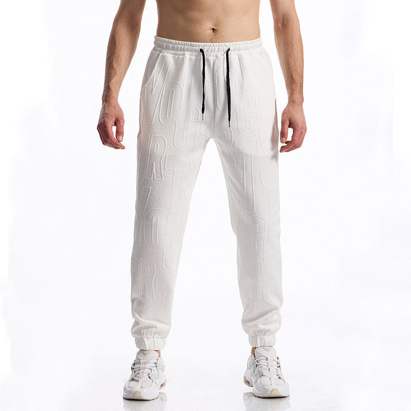 Men's jogging pants with elastic waistband, drawstring, and embossed all-over logo relief Mune Fashion