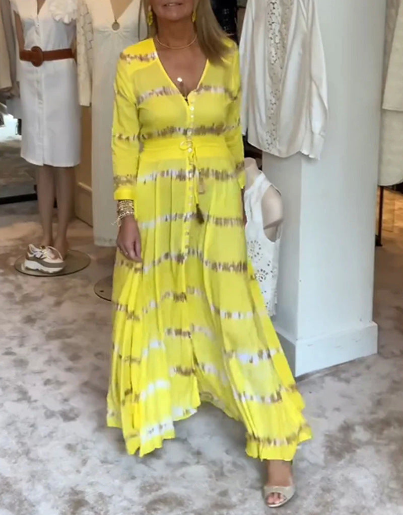 Women's flowing maxi dress with V-neck, full button placket, fitted tassel belt, and pleated skirt Mune Fashion