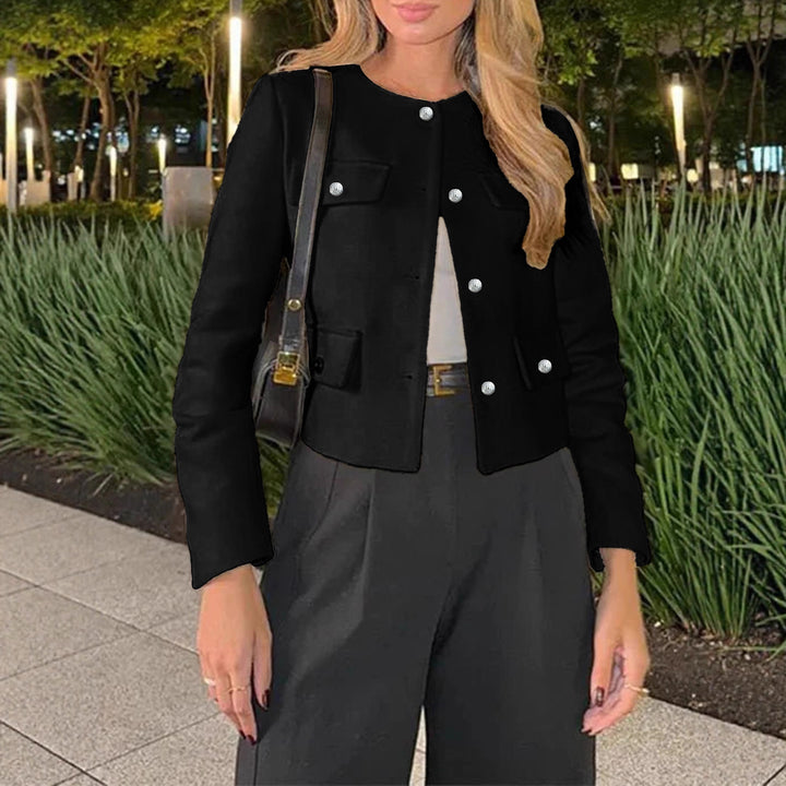 Women's short jacket in bouclé style with round neckline, decorative buttons, and patch pockets.