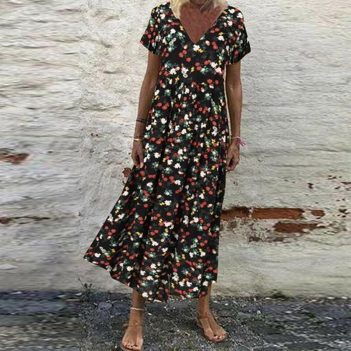 Women’s V-neck maxi dress with fine pleated skirt, empire bodice and short sleeves Mune Fashion