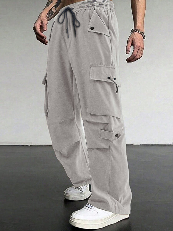 Men's baggy cargo pants with utilitarian flap pockets, drawstring waistband, and reinforced seams Mune Fashion