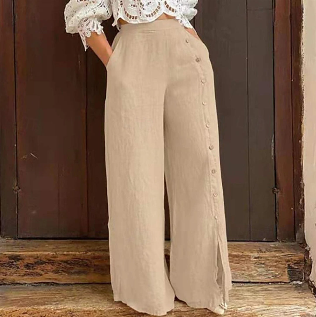 Women's high-waisted linen trousers with a side decorative button placket, side pockets, and wide leg cut Mune Fashion