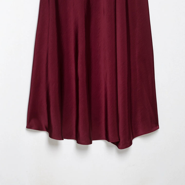 Women's flowy midi skirt in satin look with high waistband and asymmetrical hem Mune Fashion