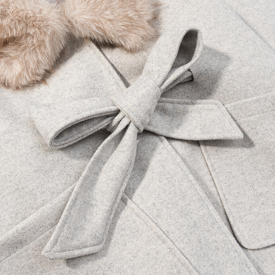 Women's hooded coat in cape cut with faux fur collar, tie belt, and patch pockets Mune Fashion