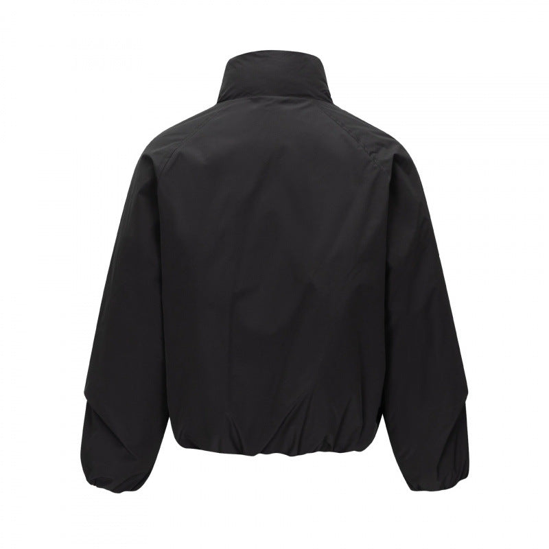 Unisex Short cut lightweight windbreaker in boxy cut with high stand-up collar and elastic hem Mune Fashion