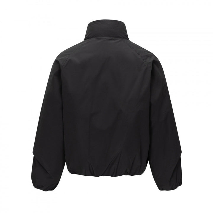 Unisex Short cut lightweight windbreaker in boxy cut with high stand-up collar and elastic hem Mune Fashion