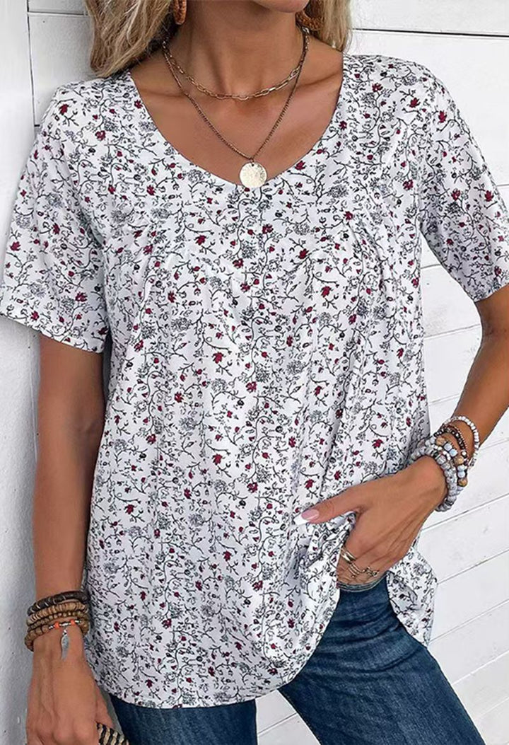 Ladies casual short-sleeve tunic shirt with round neckline, delicate all-over floral print and decorative chest pleats Mune Fashion