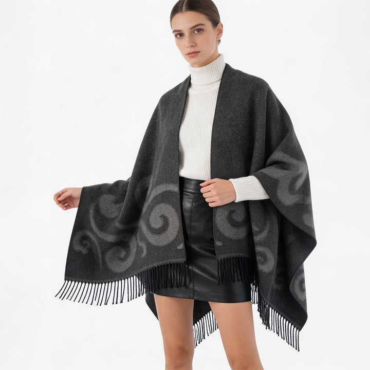 Women's wool blend poncho with jacquard swirl pattern, V-neck and fringes