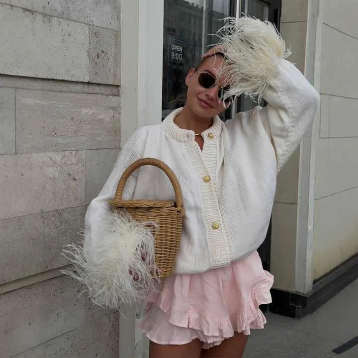 Women's knitted cardigan with feather trim at sleeve cuffs and golden decorative buttons Mune Fashion