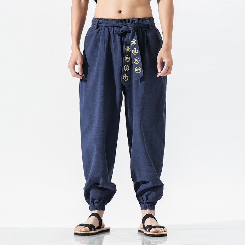 Women's wide linen trousers with drawstring waistband, binding detail, and elastic ankle cuffs Mune Fashion