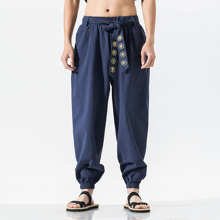 Women's wide linen trousers with drawstring waistband, binding detail, and elastic ankle cuffs Mune Fashion
