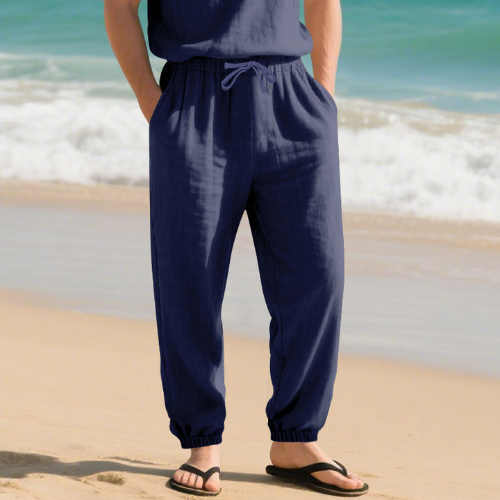 Men's light linen pants with elastic tunnel drawstring waistband, side pockets, and smocked cuffs Mune Fashion