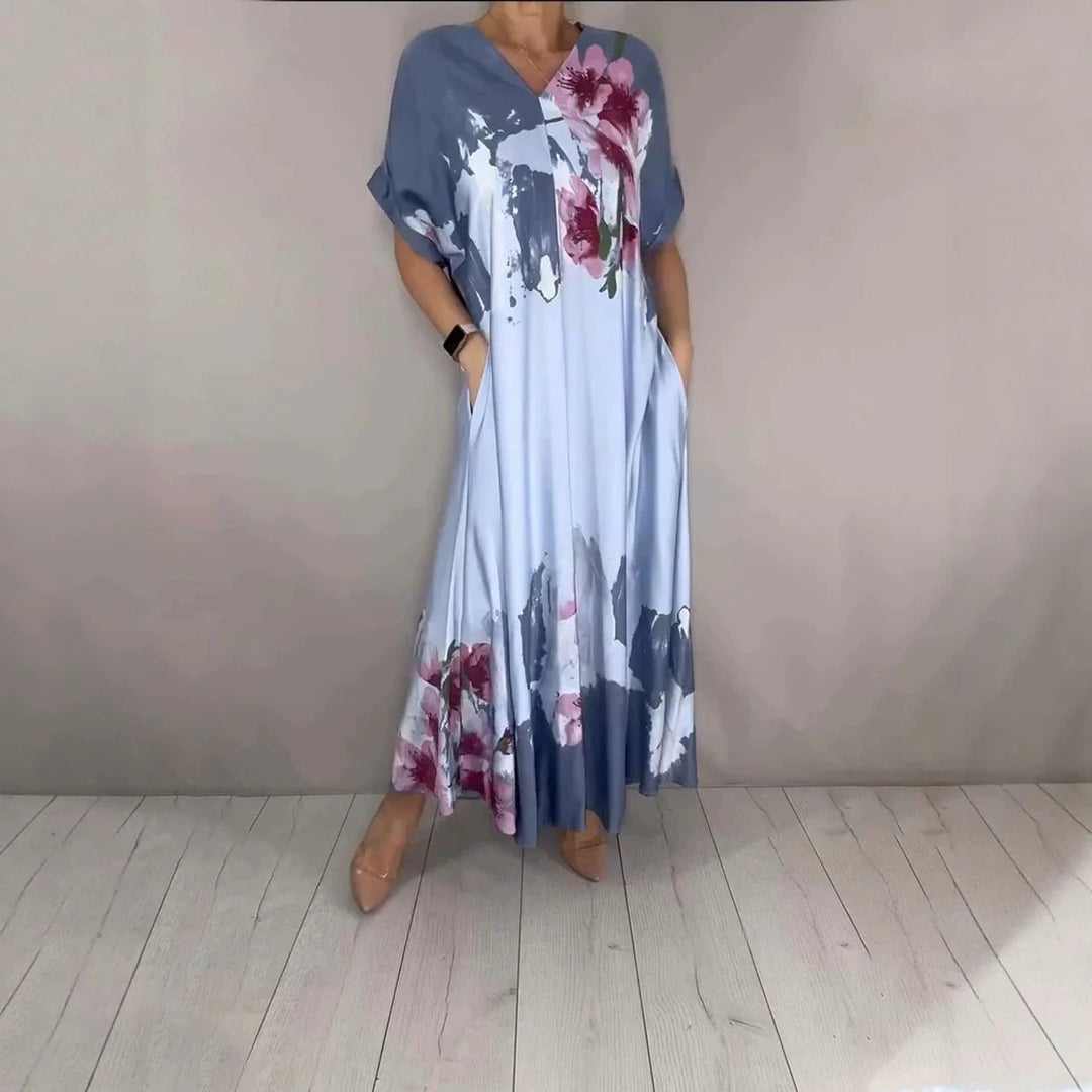 Women's maxi dress with a flowing fall, V-neck, side pockets, and floral watercolor look Mune Fashion