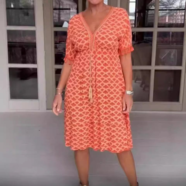 Women's casual midi dress in kaftan style with V-neck, tassel band, gathered empire seam, and fringe sleeves Mune Fashion