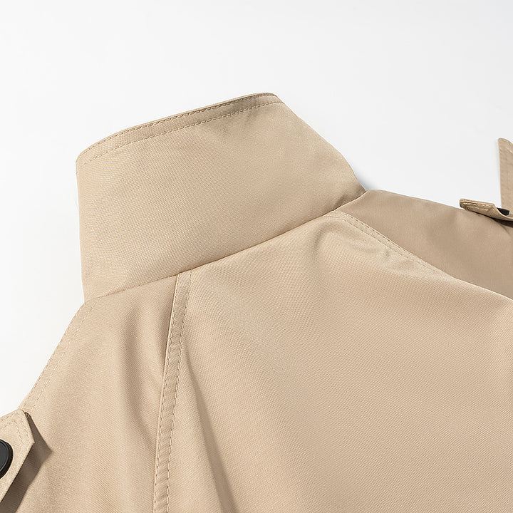 Women’s short trench coat in cropped cut with funnel collar and tie belt Mune Fashion