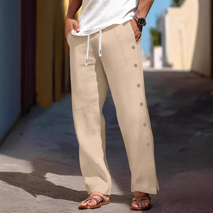 Men's loose leisure pants with side decorative button placket, drawstring waistband, and deep front pockets Mune Fashion