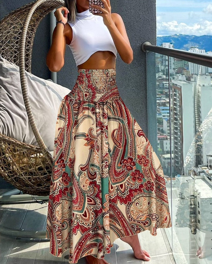 Women's maxi skirt with high smocked waistband, wide fall, and paisley print Mune Fashion